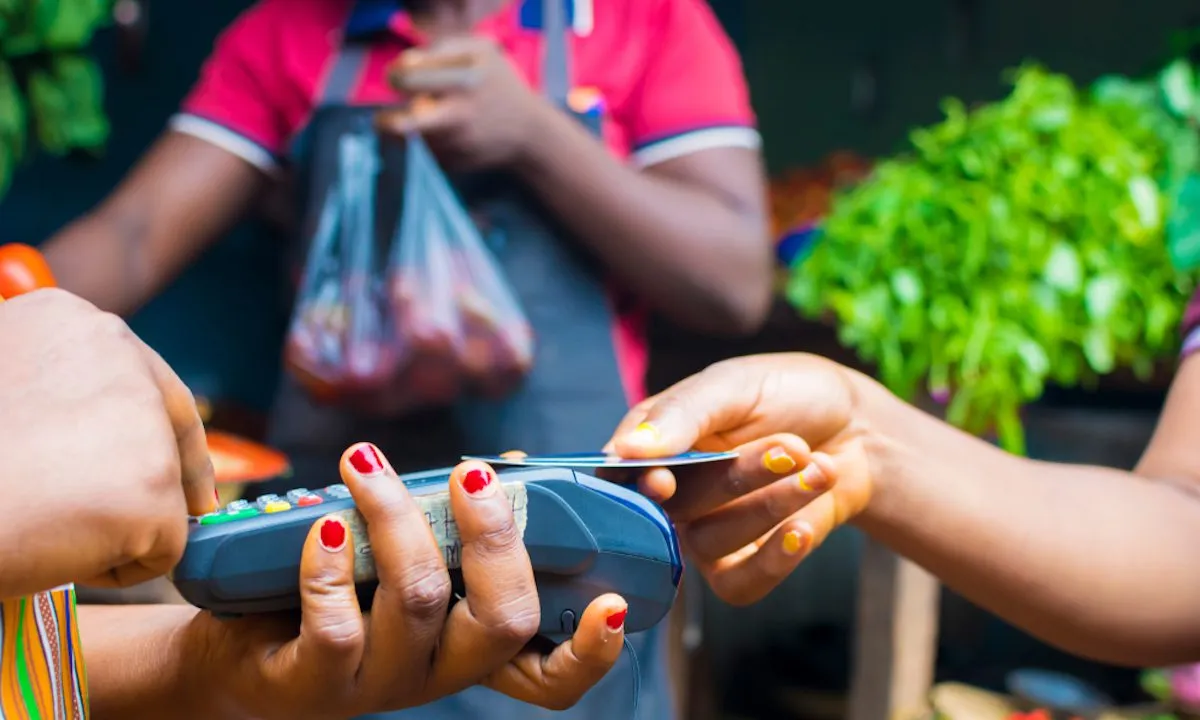 Someone using PoS for payment in an African market